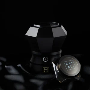 Oudgasm Diamond Bakhoor Burner on black silk beside a small Kayali bakhoor jar