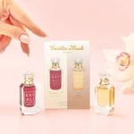 Vanilla Musk Mini Duo packaging card between the two minis, with a hand above and a white orchid