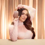 Woman holding the Freedom Musk Santal | 34 bottle near her face