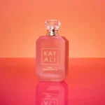 Eden Sparkling Lychee | 39 Kayali Eau de Parfum bottle on an orange background