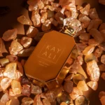 Invite Only Amber | 23 bottle lying among amber crystals and flowers