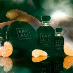 Oudgasm Tobacco Oud | 04 bottles with orange slices on a dark background