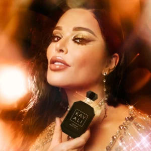 Woman holding an Oudgasm Vanilla Oud | 36 bottle near her face