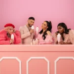 Group of women enjoying pink treats at a pink counter