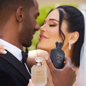 Bride and groom holding a The Wedding Velvet Santal | 35 bottle at a wedding