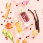 Vanilla Musk Mini Duo minis in a flat lay with vanilla pods, pink peppercorns, amber resin and a sugar cube