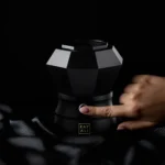 Finger pressing the power button on the Oudgasm Diamond Bakhoor Burner