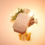 Freedom Musk Santal | 34 bottle lying among flowers and amber resin on pink