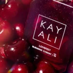 Close-up of a Lovefest Burning Cherry | 48 bottle among dark cherries